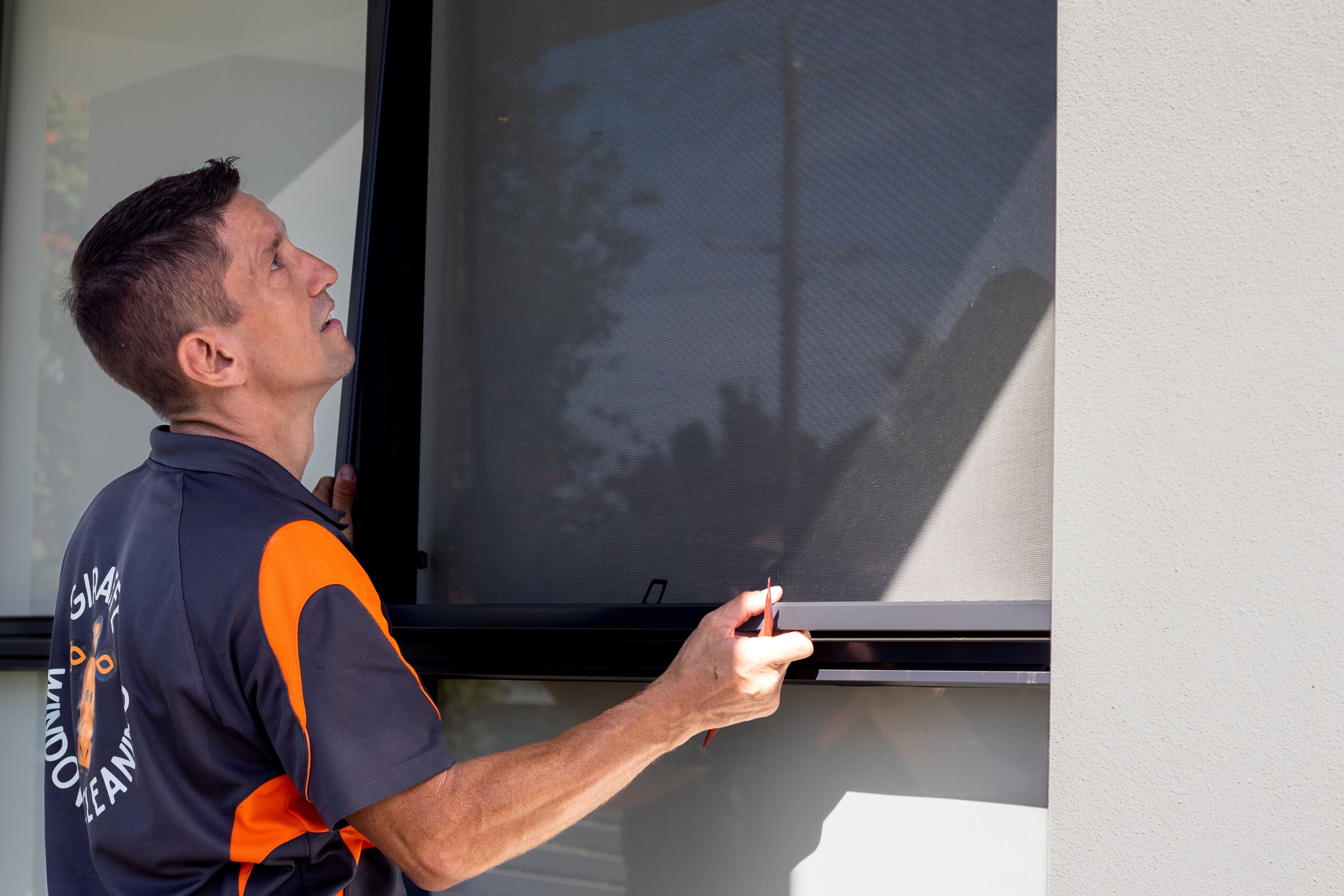 Darren cleaning fly screens Brisbane