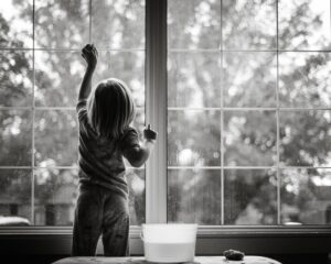A child cleaning windows